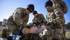 U.S. Army Soldiers with the 36th Medical Company Area Support treat a combat casualty mannequin during a field exercise and operational assessment in Fort Liberty, North Carolina, on Nov. 2, 2023.  (Photo by T. T. Parish/U.S. Army)